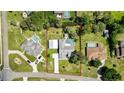 Aerial view of property showcasing a large lot, swimming pool, car port, and well-manicured lawn at 13295 Don Loop, Spring Hill, FL 34609