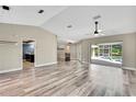 Open-concept living room flows seamlessly to the kitchen and the screened-in lanai and pool area at 13295 Don Loop, Spring Hill, FL 34609