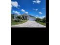 Well maintained single story home with paved driveway and tropical landscaping at 15301 Chinook Way, Port Charlotte, FL 33981