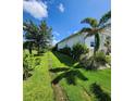 Beautifully maintained lawn with lush landscaping along the side of the house at 15301 Chinook Way, Port Charlotte, FL 33981