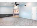 Inviting living room features plush carpeting, a modern ceiling fan, and a fresh two-tone paint scheme at 4358 Murdock Ave, Sarasota, FL 34231