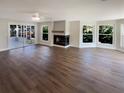 Spacious living room with sleek hardwood floors and a cozy fireplace at 5511 Drinkard Dr, New Port Richey, FL 34653