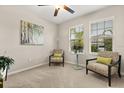 Bright bedroom with natural light, neutral tones, and cozy seating by the windows, offering a relaxing space at 4704 Wild Senna Blvd, Tampa, FL 33619