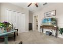 A bright bedroom featuring a closet, an entertainment center, and natural lighting from an adjacent room at 4704 Wild Senna Blvd, Tampa, FL 33619
