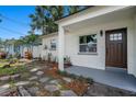 The property features a manicured lawn, stepping stone walkway, and brown front door at 6208 S Harold Ave, Tampa, FL 33616