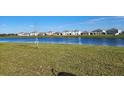 The backyard has a large lake and many similar homes on the far side of the lake at 16650 Windmill Forge Pass, Wimauma, FL 33598