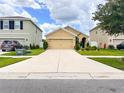 Suburban single Gathering home with an attached garage and a long driveway at 11124 Leland Groves Dr, Riverview, FL 33579