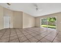 Open-concept living room with sliding glass door, tile flooring and neutral colors at 1236 Sweet Gum Dr, Brandon, FL 33511