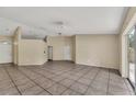 Spacious living room with neutral walls, tiled flooring, and ample natural light from sliding glass doors at 1236 Sweet Gum Dr, Brandon, FL 33511