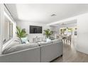 Open concept living space with neutral colors, hardwood floors, and ample natural light at 707 63Rd S Ave, St Petersburg, FL 33705