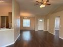Inviting living room with beautiful wood floors, fan, window and views to entry at 837 Greenbelt Cir, Brandon, FL 33510