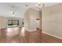 Open-concept living room and dining area with wood floors and natural light at 837 Greenbelt Cir, Brandon, FL 33510