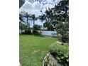 Expansive backyard featuring lush green grass, mature trees, and a white privacy fence at 4924 Creekside Trl, Sarasota, FL 34243