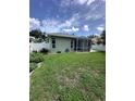 Lush backyard with a screen enclosed lanai and privacy fence at 4924 Creekside Trl, Sarasota, FL 34243