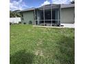 Beautiful screen enclosed lanai with paved patio and well-maintained lawn at 4924 Creekside Trl, Sarasota, FL 34243