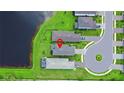 Aerial view of a home and community with lush greenery and lake access at 6256 Baywood Ct, Bradenton, FL 34211