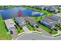 Aerial view of a home with a lake view, beautiful landscaping, and proximity to a serene lake at 6256 Baywood Ct, Bradenton, FL 34211