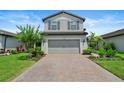 Well-maintained two-story home with a paved driveway and neatly landscaped front yard at 6256 Baywood Ct, Bradenton, FL 34211