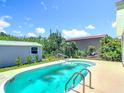 Backyard pool featuring a large lounge area and mature landscaping providing a relaxing outdoor space at 7341 Hart St, Englewood, FL 34224