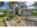 Two-story home with attractive landscaping and a manicured front yard at 7716 Nottinghill Sky Dr, Apollo Beach, FL 33572