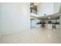 Open-concept living area with tile flooring and ample natural light; adjoining kitchen visible at 7716 Nottinghill Sky Dr, Apollo Beach, FL 33572