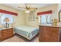Cozy bedroom with ceiling fan, carpet, and decorative touches at 8490 7Th Ln N,, St Petersburg, FL 33702