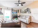 Bright living room with a ceiling fan, ample natural light, and comfortable furnishings at 1244 E Corktree Cir, Port Charlotte, FL 33952