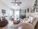 Inviting living room with vaulted ceilings, a ceiling fan, and a comfortable seating arrangement at 1244 E Corktree Cir, Port Charlotte, FL 33952
