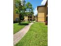 Exterior of building showcasing the walkway and landscaping at 4307 Bayside Village Dr # 103, Tampa, FL 33615