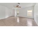 Bright living room with tile floors, a ceiling fan, and lots of natural light from the windows at 5145 Prairie View Way, Wesley Chapel, FL 33545