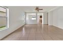 Spacious living room with tile floors and view to the kitchen creates an open concept at 5145 Prairie View Way, Wesley Chapel, FL 33545