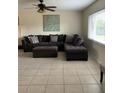 Comfortable living room featuring a large sectional sofa, ottoman, and a decorative piece of artwork at 1409 Yorkshire St, Port Charlotte, FL 33952