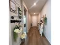 Inviting hallway featuring stylish decor, wood flooring, and natural light at 3567 74Th Avenue E Cir, Sarasota, FL 34243