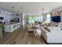 Spacious open-concept living room and kitchen with hardwood floors at 3567 74Th Avenue E Cir, Sarasota, FL 34243