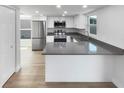 Modern kitchen with stainless steel appliances, gray countertops, and bright natural light at 4506 Shadberry Dr, Tampa, FL 33624