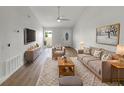 Bright living room with stylish furniture, area rug, and large TV for relaxation at 4506 Shadberry Dr, Tampa, FL 33624