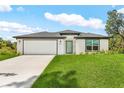 Beautiful one-story home with a lush lawn and attached two-car garage at 4798 Jody Ave, North Port, FL 34288