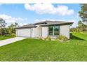 Beautiful one-story home with a lush lawn and attached two-car garage at 4798 Jody Ave, North Port, FL 34288