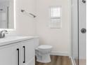 Clean renovated bathroom with sleek vanity, illuminated mirror, and walk-in shower at 7635 Pier Rd, Port Richey, FL 34668