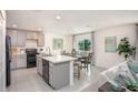 Modern kitchen features stainless steel appliances, a center island, and a view to the dining area at 14037 Canada Goose Rd, Brooksville, FL 34614
