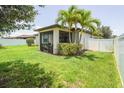 Expansive backyard with well-maintained lawn, screened patio, and privacy fence, ideal for outdoor living at 2647 Running Oak Ct, North Port, FL 34289