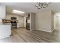 Updated kitchen with stainless steel appliances and white cabinetry at 8744 Candlewick Ln, Port Richey, FL 34668
