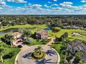 Expansive aerial view showcasing a well-maintained property with water views and a golf course at 7315 Bianco Duck Ct, Sarasota, FL 34240
