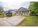 Inviting home featuring a spacious driveway and a well-maintained lawn; perfect for families at 3610 N Tampa St, Tampa, FL 33603