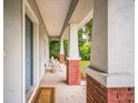 Relaxing front porch with seating and brick accents, creating a welcoming entrance to the home at 3610 N Tampa St, Tampa, FL 33603
