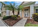 Home featuring a beautifully landscaped front entrance, charming walkway, and a stylish front door at 8749 Ashworth Dr, Tampa, FL 33647