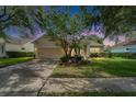 Inviting home exterior with lush green lawn, mature trees, and a well-maintained landscape at 8749 Ashworth Dr, Tampa, FL 33647