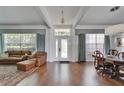 Bright living room featuring hardwood floors, coffered ceilings, large windows and elegant furniture at 8749 Ashworth Dr, Tampa, FL 33647