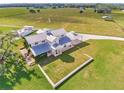 Aerial view of a farmhouse with a covered porch and large yard at 15200 Rawls Rd, Sarasota, FL 34240