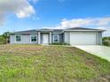 New construction home with gray siding and a two-car garage at 12128 Grouse Ave, Port Charlotte, FL 33981